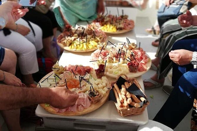 Aperitif on the boat at Sunset island and sea caves - The Sum Up