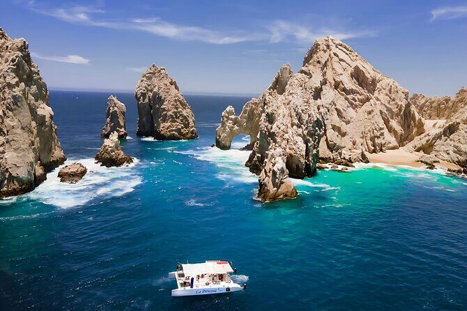 Cabo Catamaran Tour: Snorkeling & Unlimited Drinks Included - Key Points