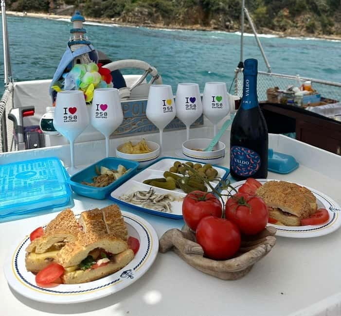 Catamaran tour along the Cefalù coast with aperitif and snorkeling - Aperitif and Local Flavors