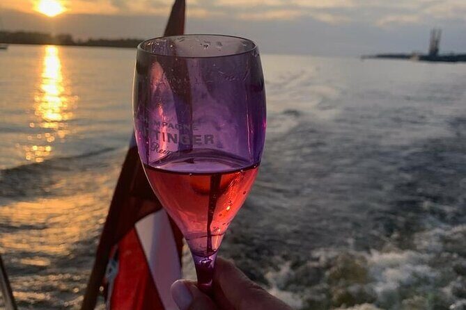 Riga: Evening or Sunset Boat Tour with Drink and Audio Guide - The Sum Up