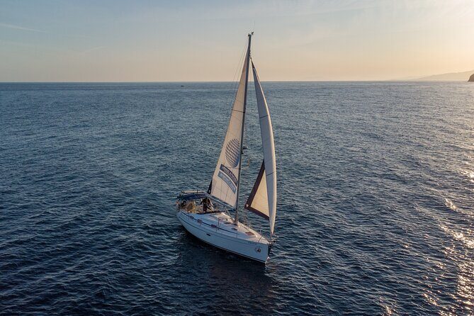 Sailing at sunset along the cliffs of Maro-Compartida - What to Expect from the Sunset Sailing Tour