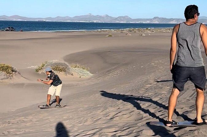 Slide into the sunset by Sandboarding in Las Dunas Del Mogote - Sunset Finale