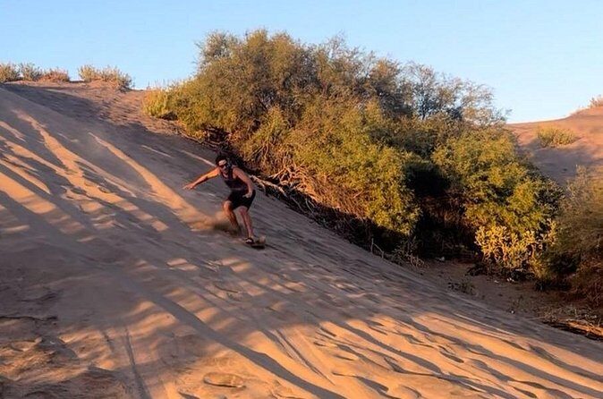 Slide into the sunset by Sandboarding in Las Dunas Del Mogote - Highlights for the Traveller