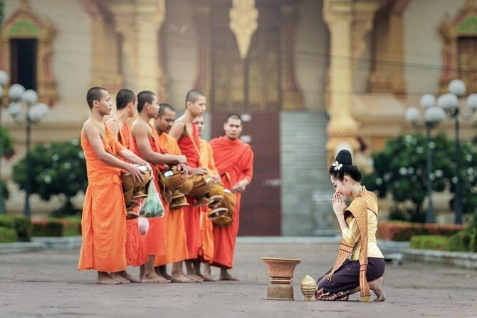 Sunrise blessing walk towards famous temple with fruit and flower donation - Key Points